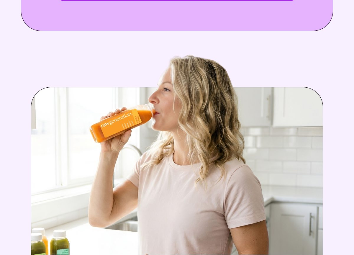 Woman drinking a juice from a bottle in a bright kitchen.
