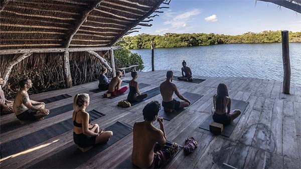 An image of people at an outdoor yoga retreat