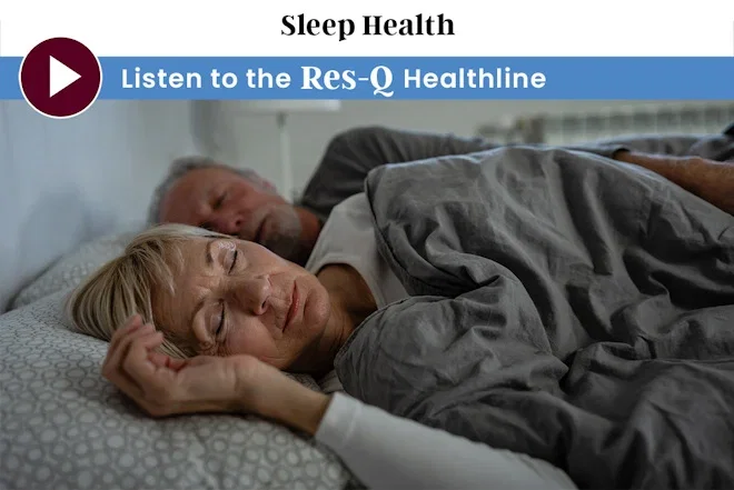 An older couple sleeps peacefully in bed