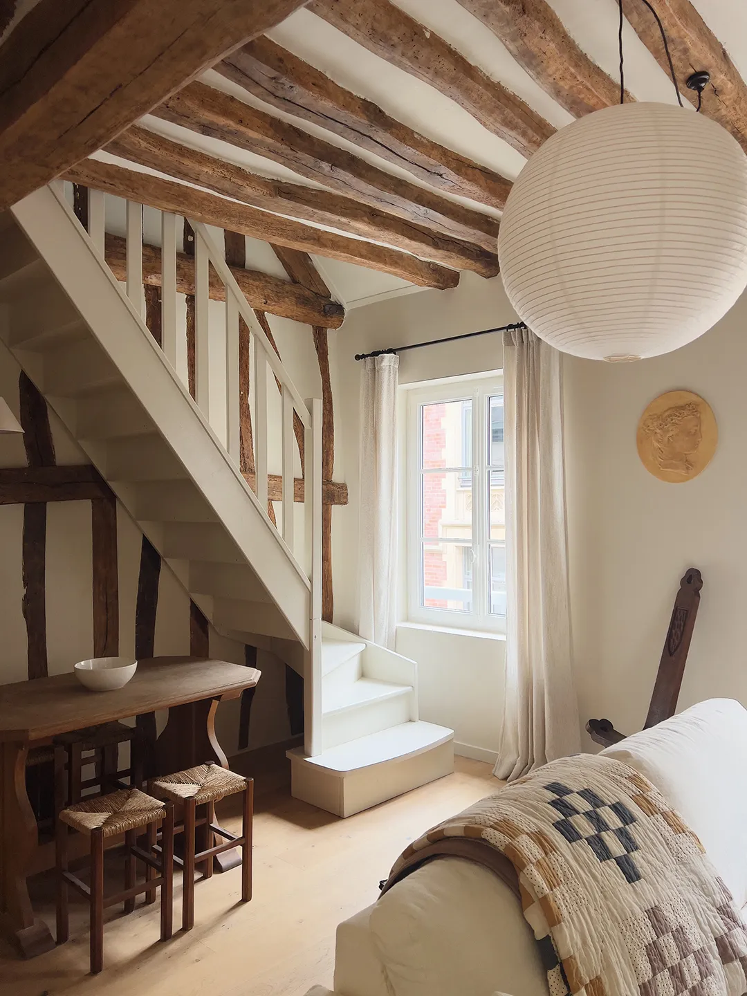 A 420-Square-Foot Normandy Apartment Where IKEA Cabinets Coexist With Historic Beams