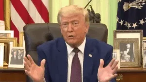 Donald Trump appears to play an imaginary accordion in the oval office.
