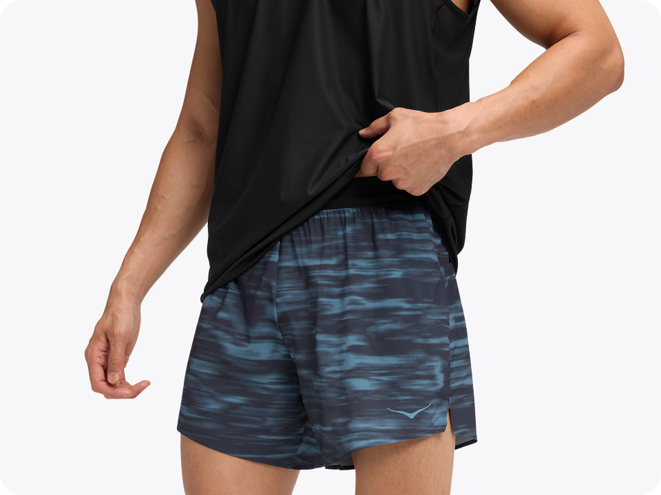 Close-up of a model wearing a performance t-shirt and running shorts.
