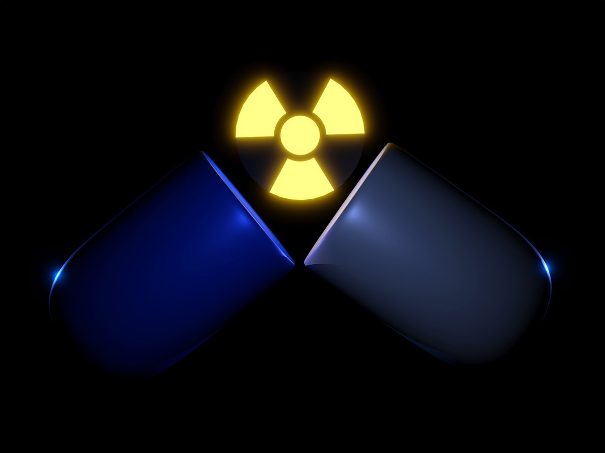 Open blue capsule with yellow radioactive symbol