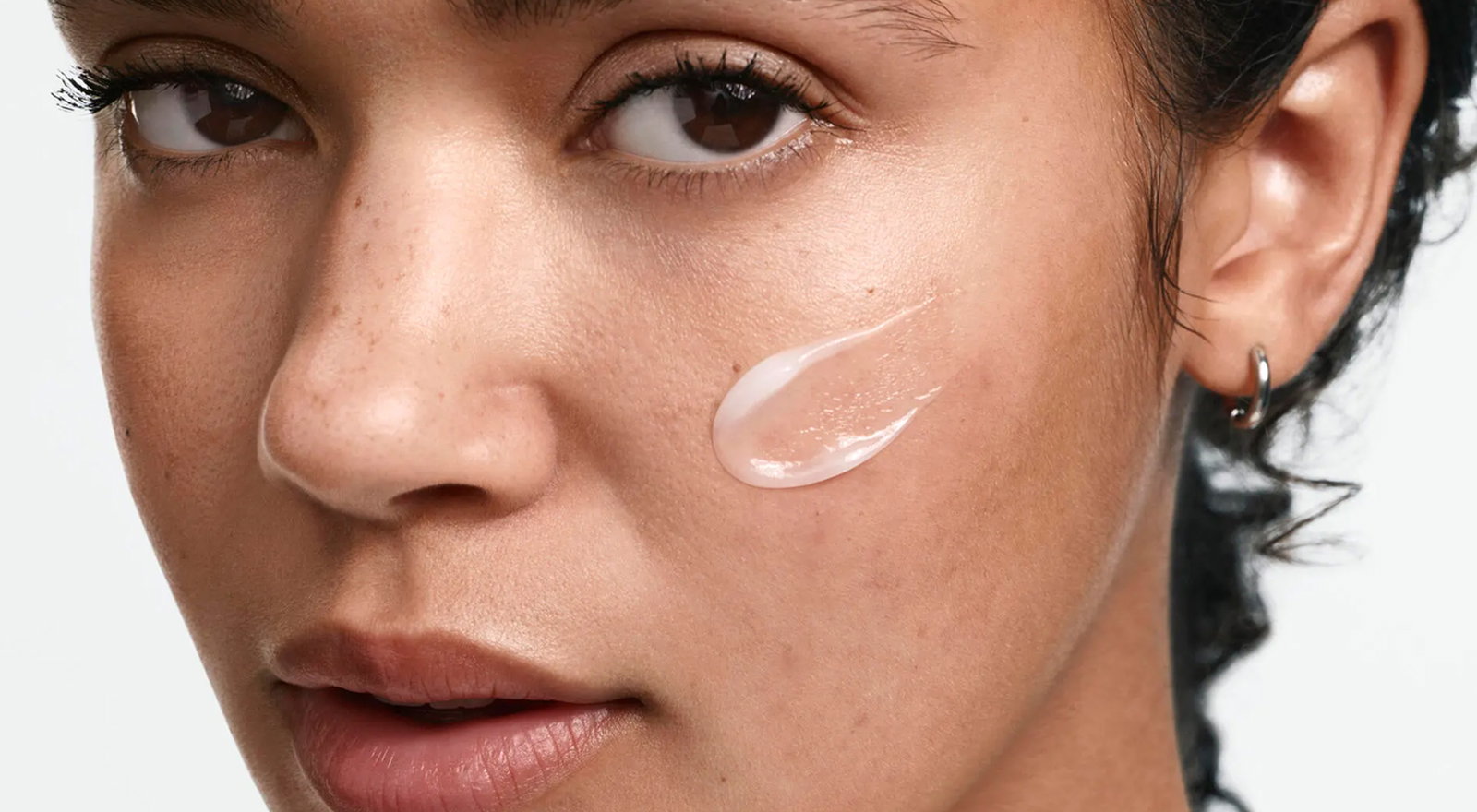 Woman Applying Neutrogena® Evenly Clear™ Acne Cleanser to face