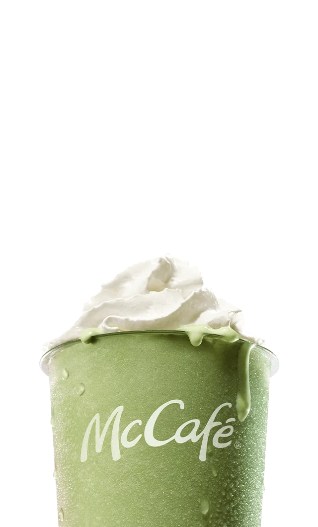 An icy, refreshing matcha latte on a blue-pink gradient background. As you scroll down the page, large white text is revealed reading 'Make it a matcha summer. Matcha blended with ice, topped with whipped cream, sweetened with vanilla'.