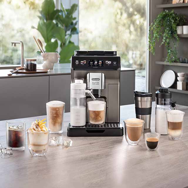 A coffee machine with various coffee drinks, cups, and mugs on a kitchen counter.