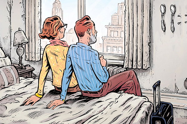 Couple sitting on a bed.