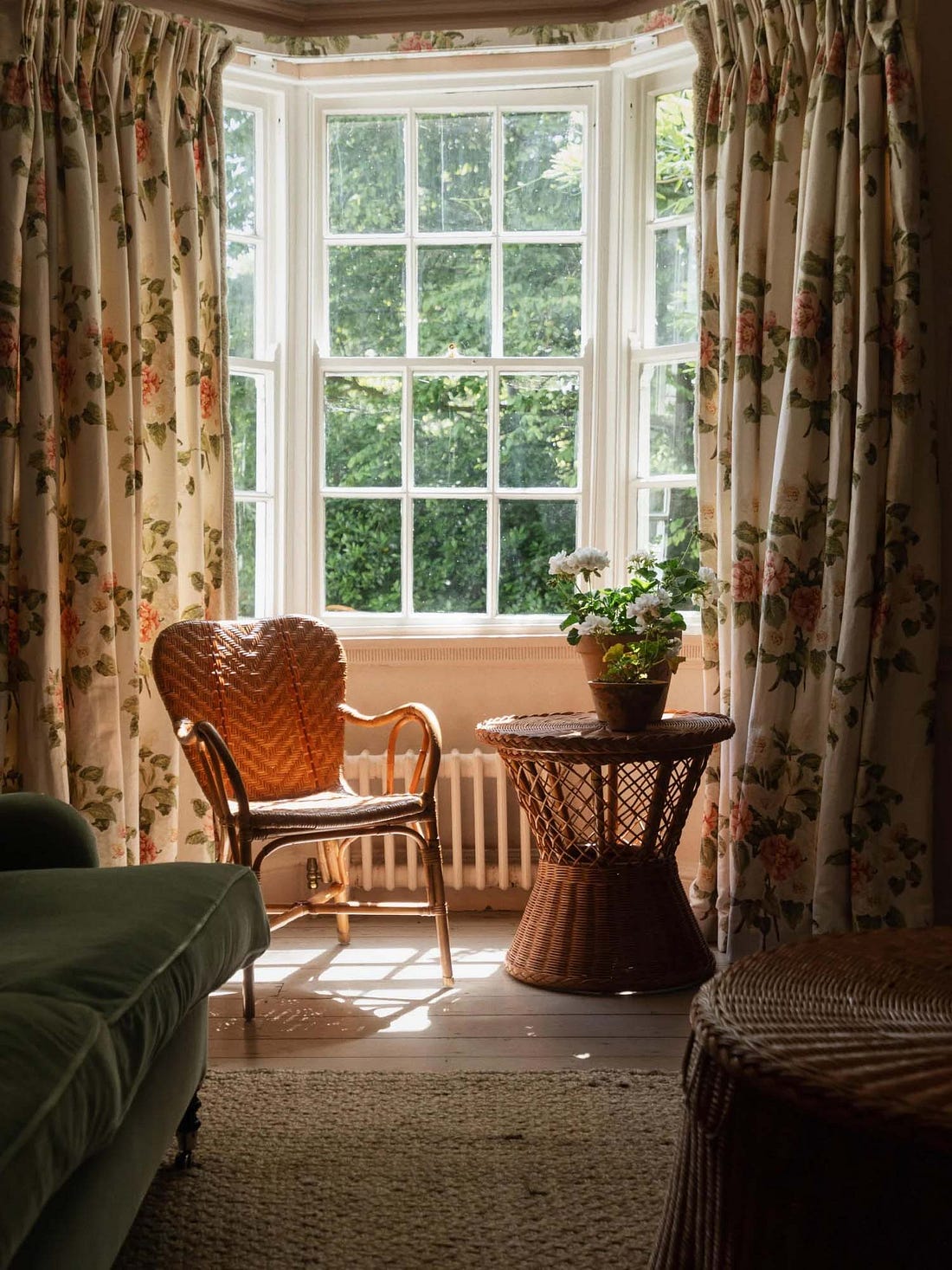 Rattan chair and accent table in front of a window
