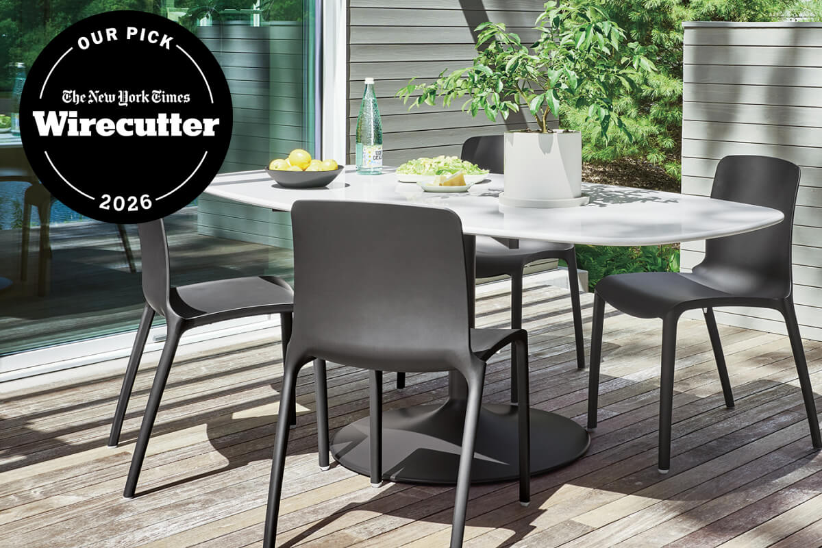 Aria outdoor dining table with white boat top and four black dining chairs on a wood deck.