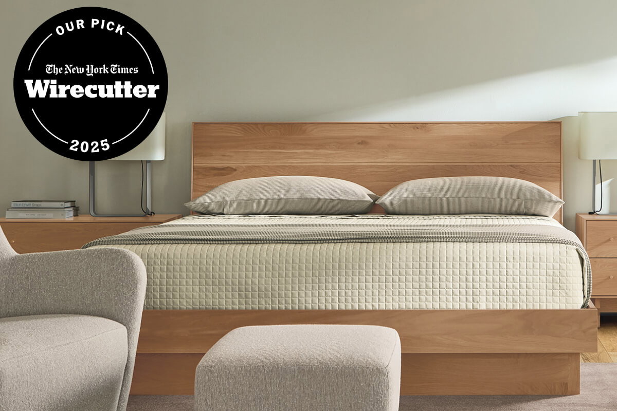 Hudson bed with wood headboard, quilted bedding and matching nightstands with table lamps.