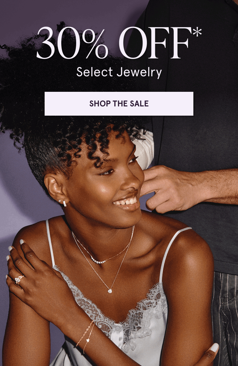 Model in dainty gold-set diamond jewelry, featuring pendants & diamond ring. 30% OFF Select Jewelry. Click here to shop now