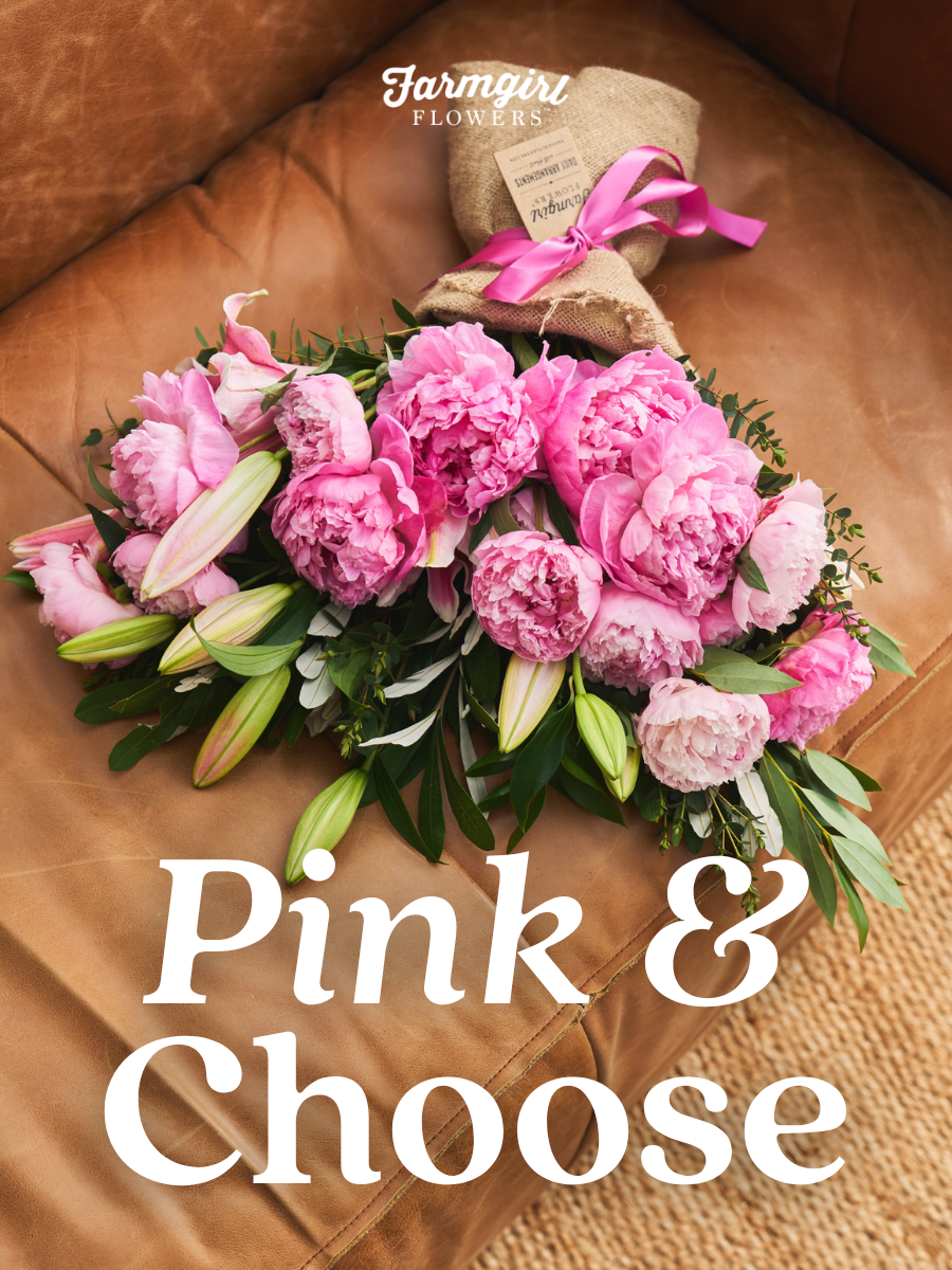 Farmgirl Flowers campaign image showing a pink peony bouquet wrapped in burlap with a bright pink ribbon, resting on a tan leather couch. White text over the image reads “PINK & CHOOSE,” with the Farmgirl Flowers logo near the top.