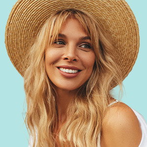 Woman smiling in a sun hat