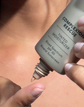 Model applying COMPLEXION RESCUE® Tinted Moisturizer with Hyaluronic Acid and Mineral SPF 30