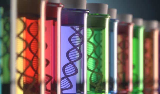 Close-up of test tubes containing colorful liquids with DNA strands visible inside each tube.