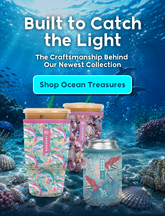 Colorful patterned tumblers and a can cooler displayed underwater among coral and seashells.