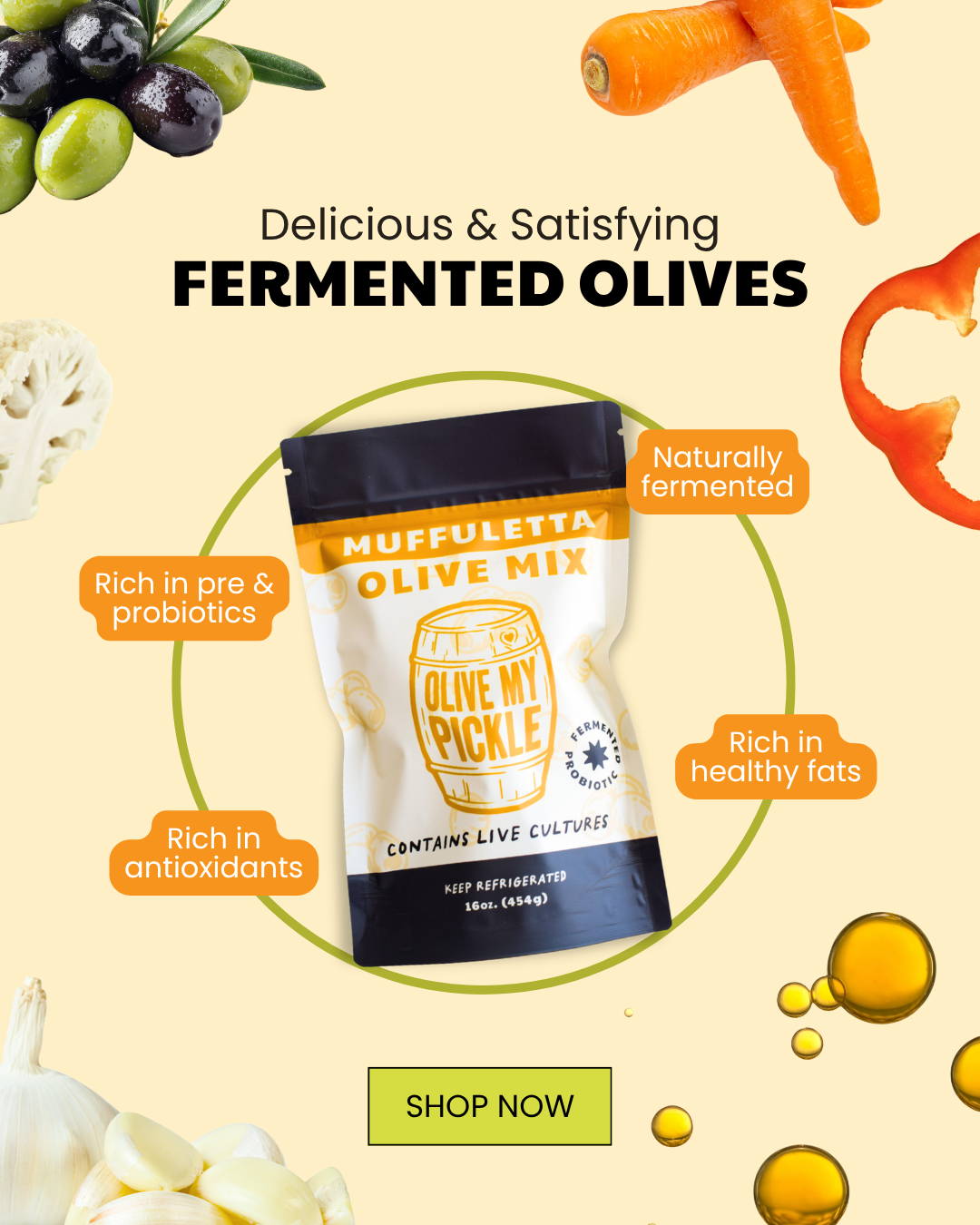 Product shot of Olive My Pickle Muffuletta Olive Mix bag, surrounded by fresh olives, carrots, cauliflower, garlic, and red bell pepper, with text highlighting