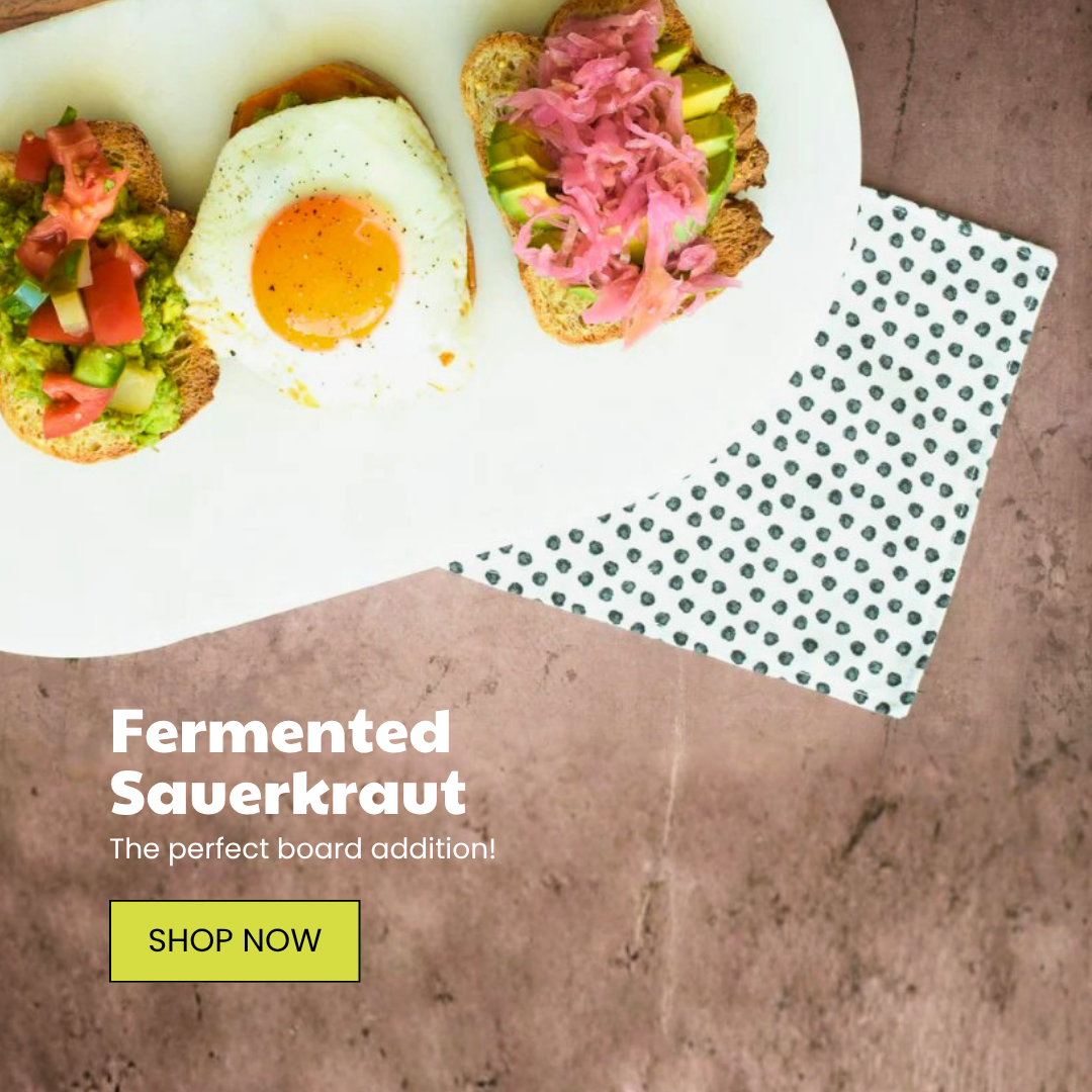 Three gourmet toasts on a white platter: avocado with fresh salsa, a fried egg, and avocado topped with pink fermented sauerkraut, on a brown surface with a pol