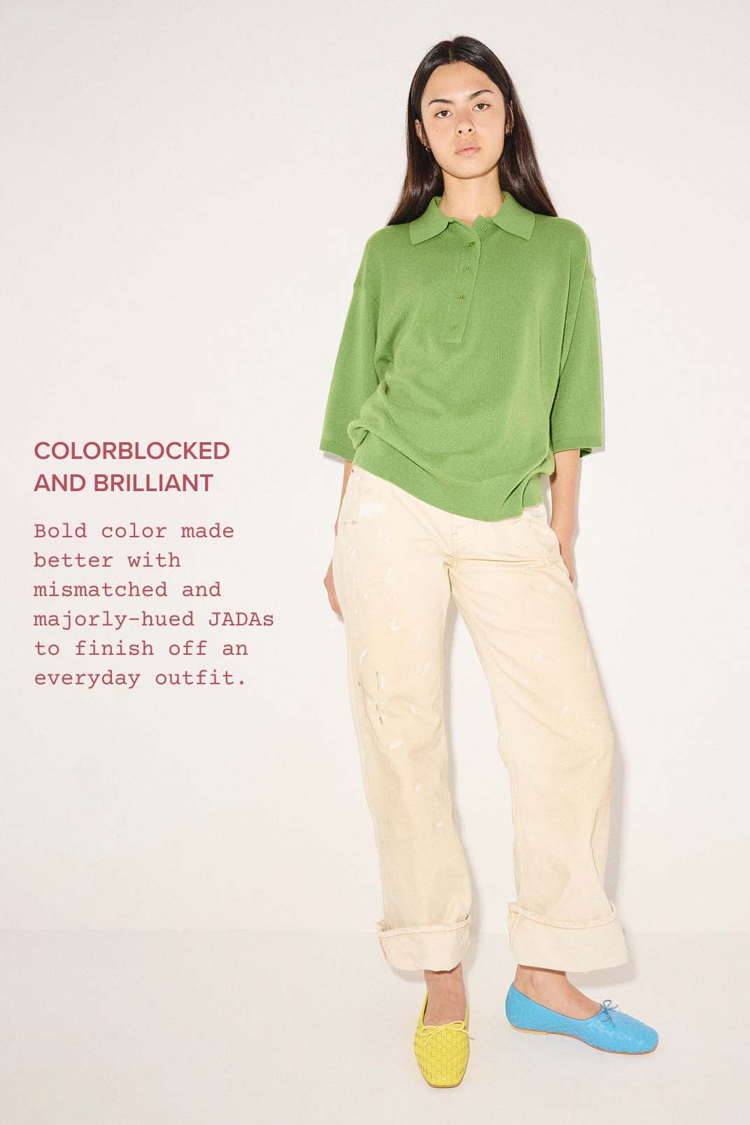 woman in green top and beige pants wearing bold color mismatched ballet flats 