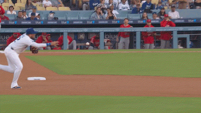 An animated gif of Miguel Rojas barehanding a ball and making a throw to first