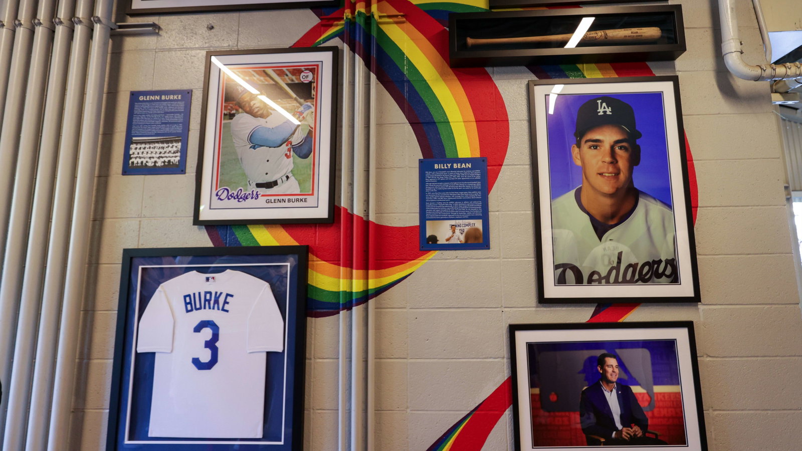 A new mural at Dodger Stadium with images and jerseys of Glenn Burke and Billy Bean over a rainbow ribbon backdrop