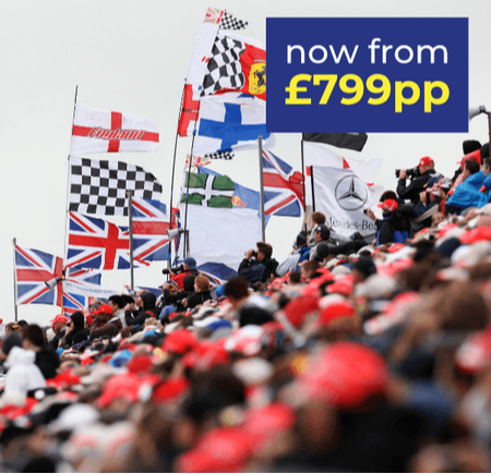 Crowd at a sporting event with various flags, including Union Jacks and checkered flags.