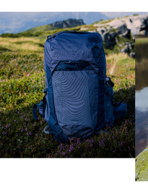 A men's Osprey Talon 22L Rucksack sitting on a trail, mountains stretching into the distance. 