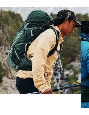 A man walks on the trail carrying camping poles, an Osprey Talon 33L Rucksack in black on his back. 