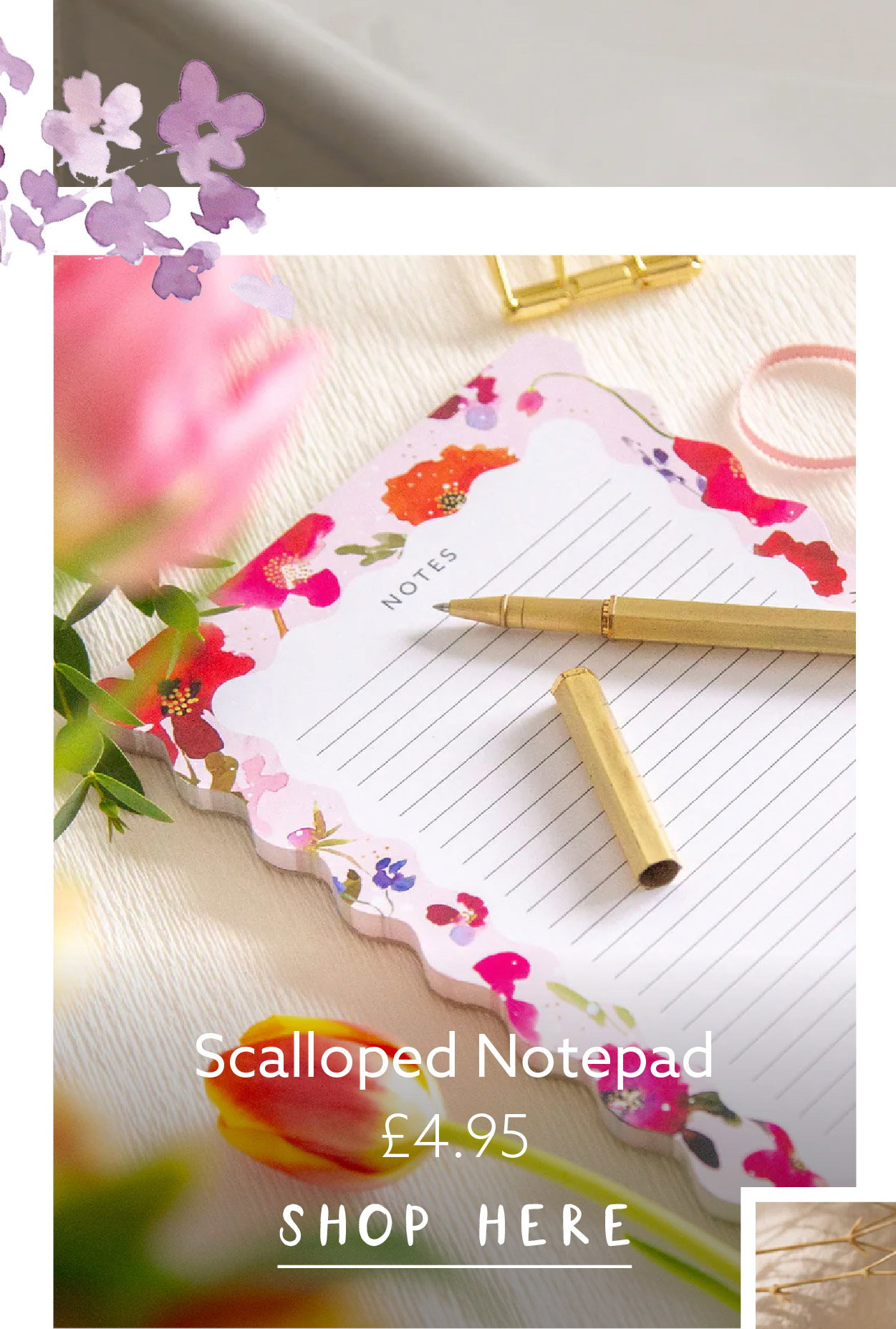 Wildflower Whispers scalloped notepad styled with a brass pen and fresh spring flowers on a bright tabletop.