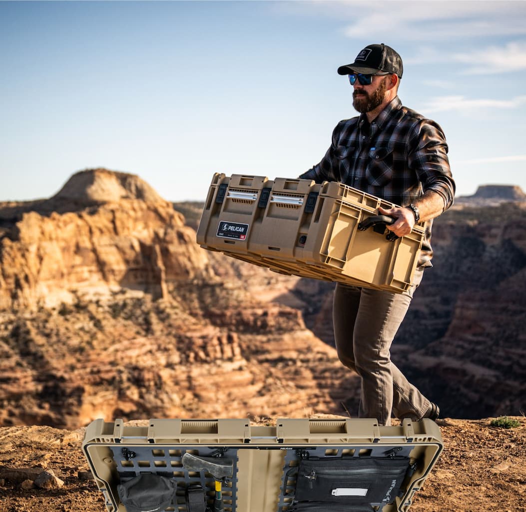 Guy walking with CRATE 90L Tan