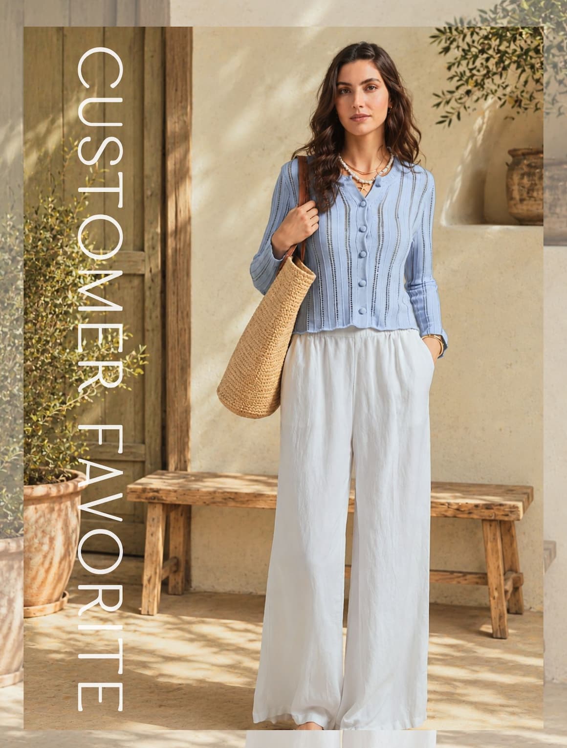A lady wearing a sky cotton pointelled cardigan.