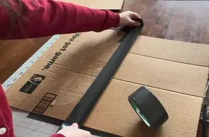 She sticks duct tape over a big piece of cardboard to make food shopping less of a chore