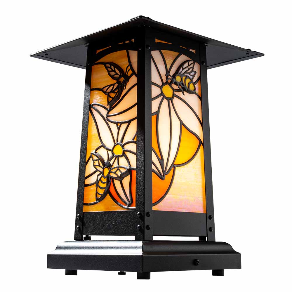 A table lamp with stacked glass bees and blossoms.