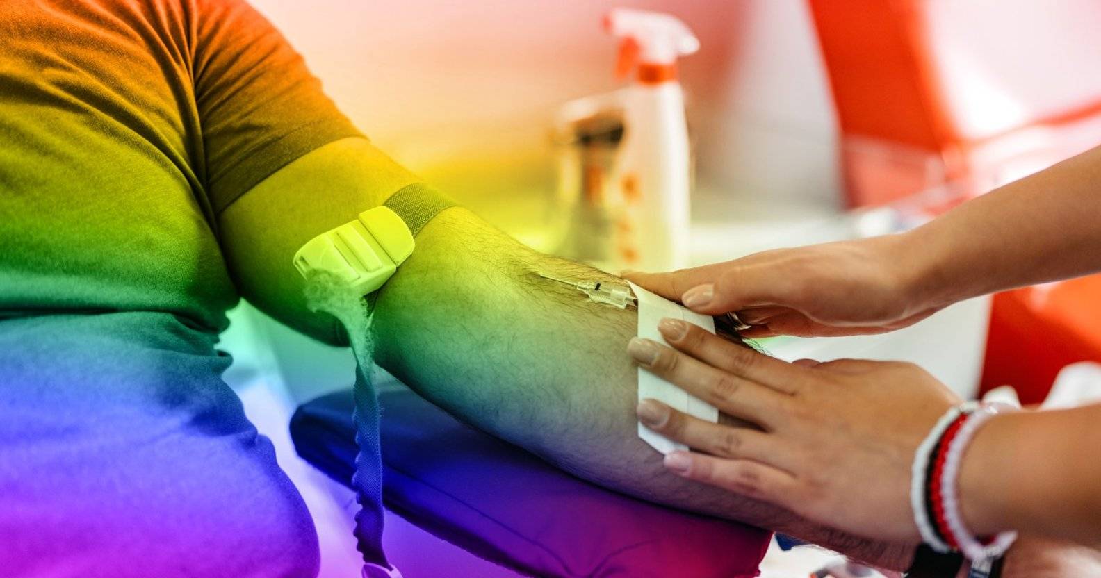 A person donating blood, a rainbow filter is over the image