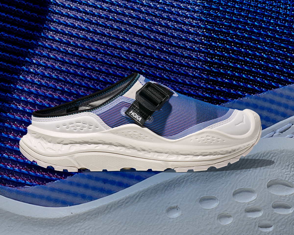 Side view image of the Ora Primo EXT CS in Frost / Neon Sky, on a textured blue background.