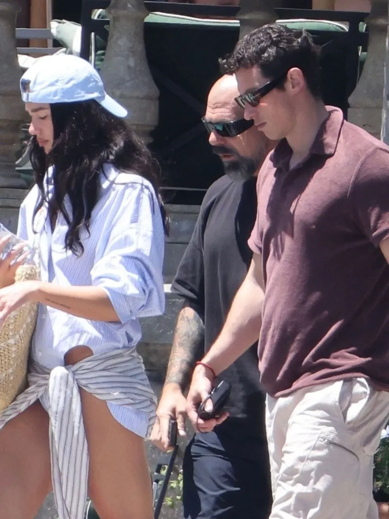 Image may contain: Callum Turner, Dua Lipa, Clothing, Shorts, Accessories, Sunglasses, Person, Skin, Tattoo, and Bracelet