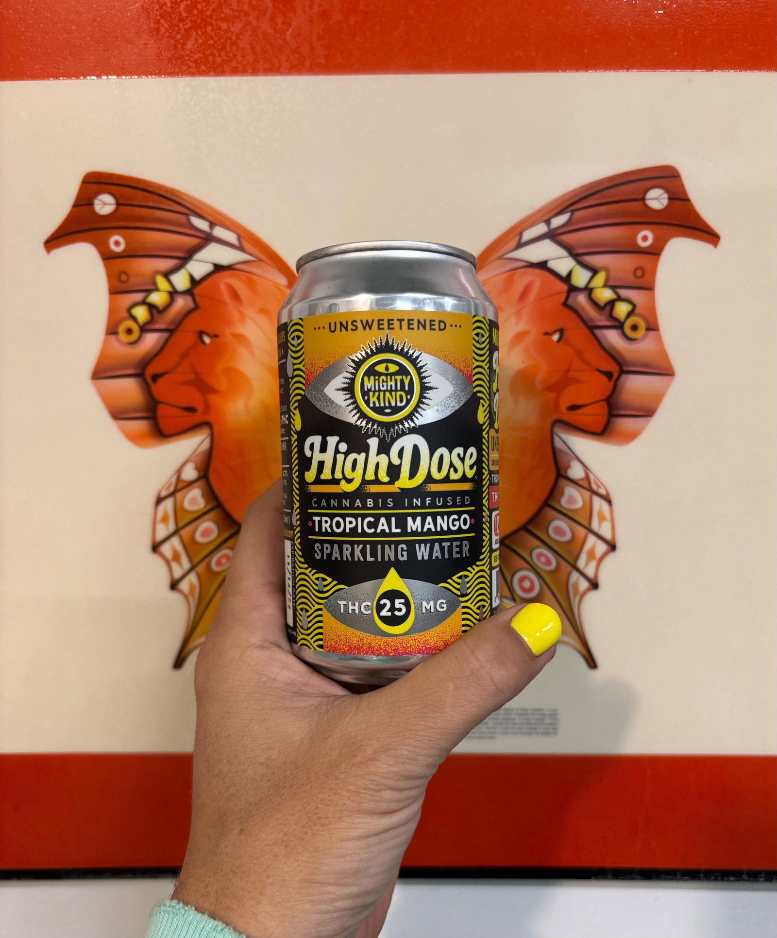 Image of someone holding a bottle of High Dose Tropical Mango Seltzer!