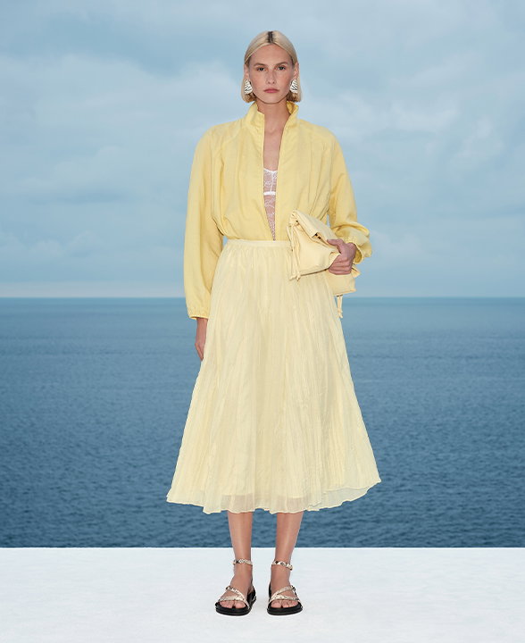 Woman wearing a Citrus Lyocell Rich Bomber Jacket with Linen and a yellow Textured Midaxi Circle Skirt