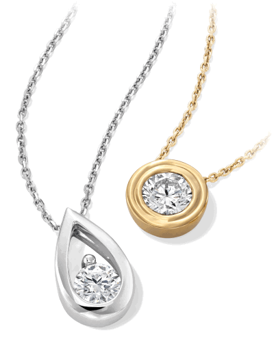 White and yellow gold necklaces with pear-shaped and round bezel-set diamond pendants.