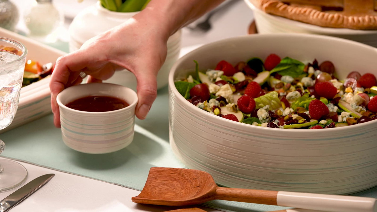 Summer berry salad with mixed greens, raspberries, feta, and balsamic dressing.