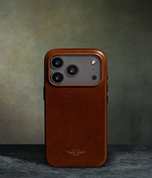 Brown leather iPhone case with embossed logo on a dark surface