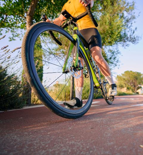 A cyclist stopping for a break with blue sky above