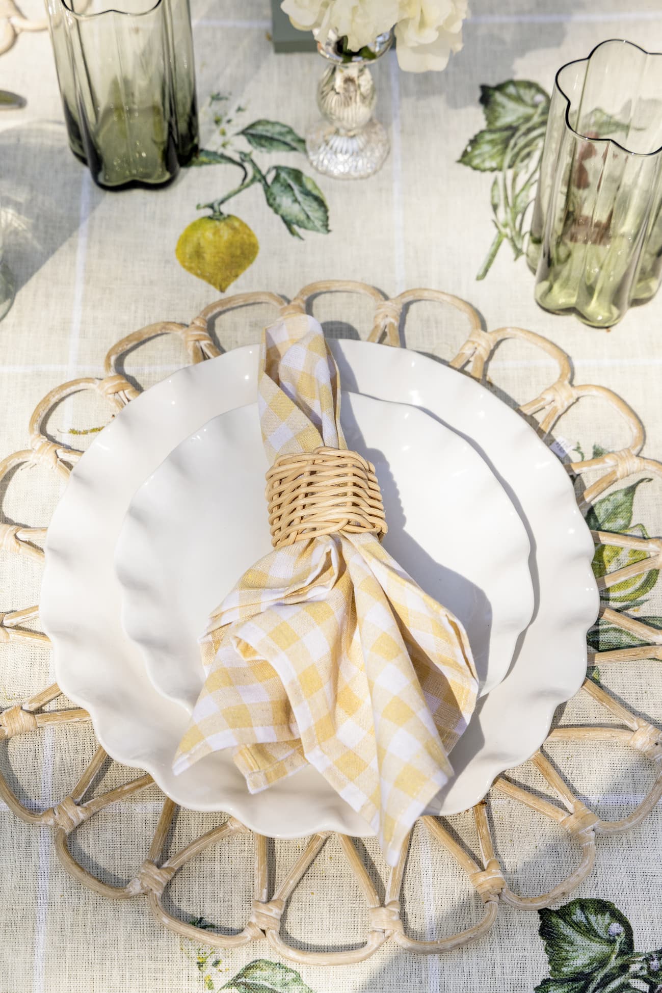 Summer place setting with ruffle plates, gingham napkin and woven napkin ring.