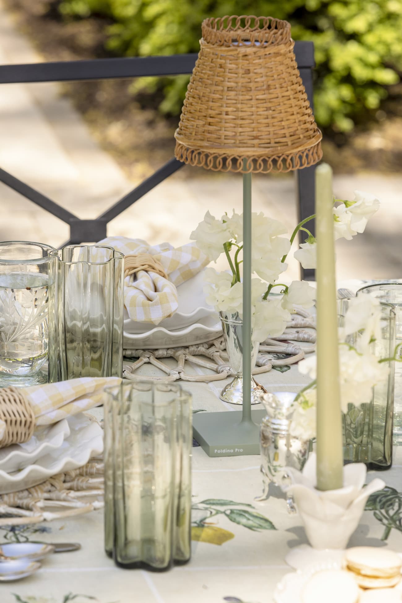 Outdoor table with outdoor lamp and rattan lampshade.