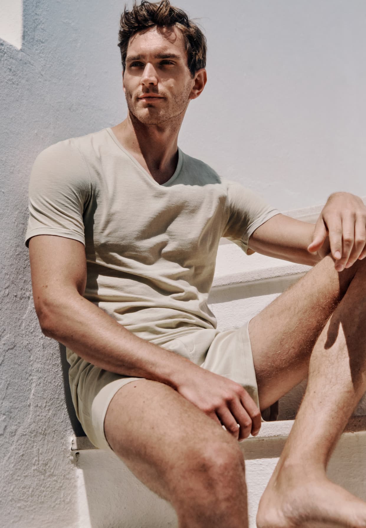 male model sitting on steps outside wearing Ultralight t-shirt and Cotton Sporty boxers
