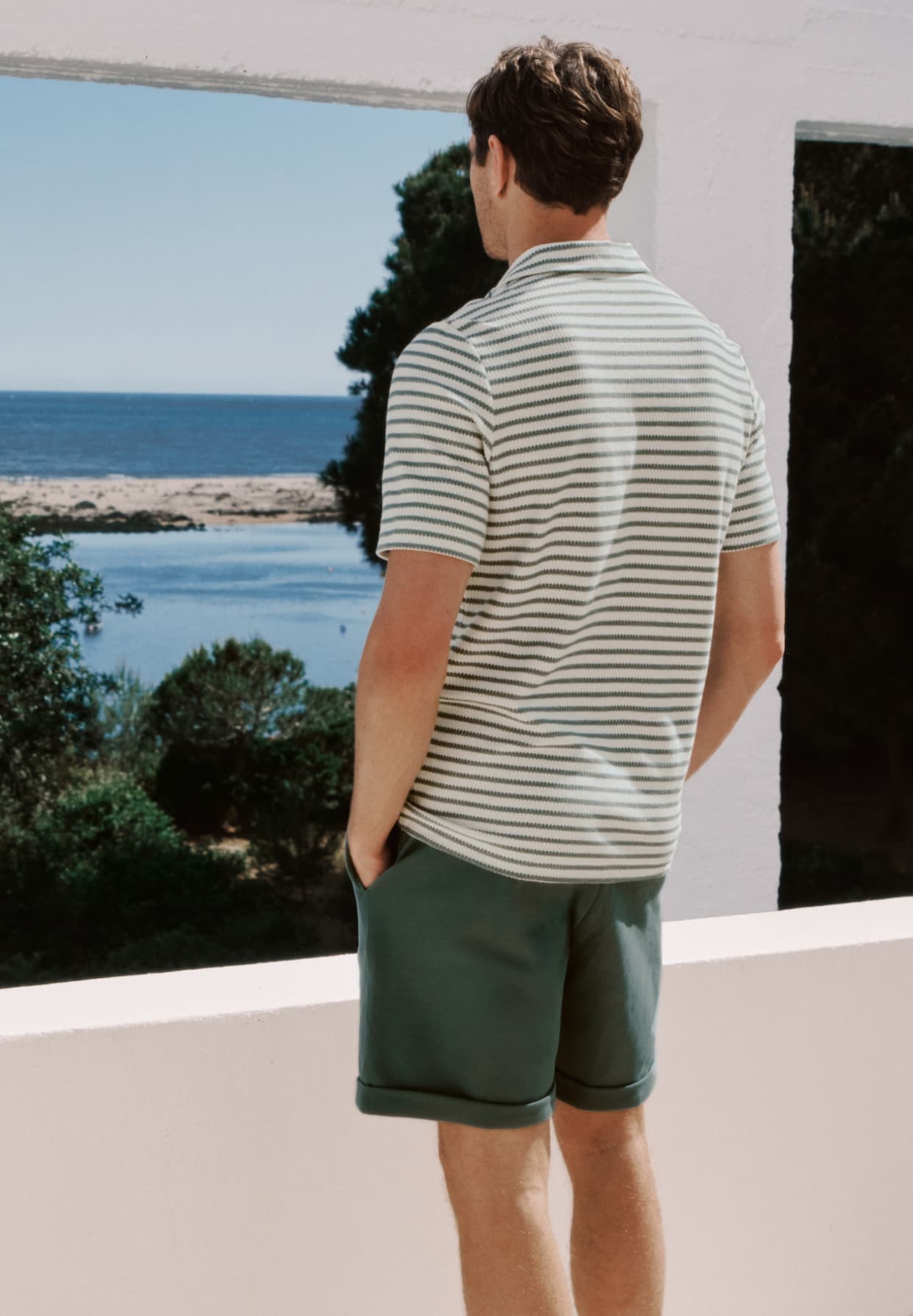 Male model posing outdoors with back to the camera, wearing Travelwear set