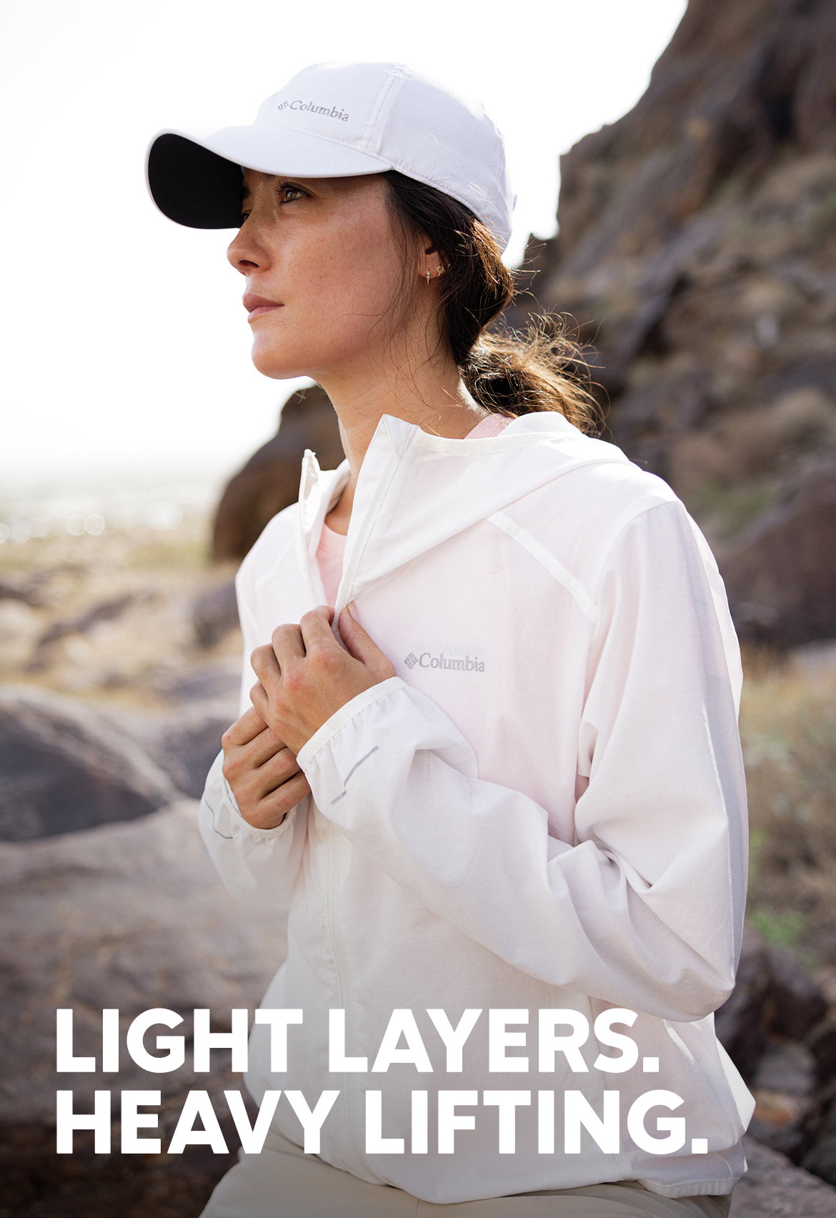 A woman in a lightweight white jacket in the desert with headline LIGHT LAYERS. HEAVY LIFTING.
