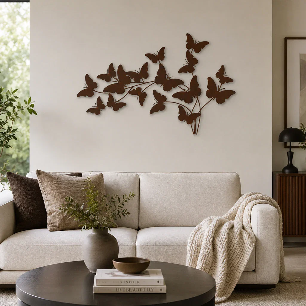 Beige curved sofa with butterfly wall art and round coffee table in modern living room décor.