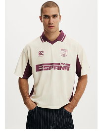 Man wearing cream and purple sports polo shirt