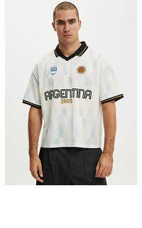 Man wearing white Argentina soccer jersey with black trim